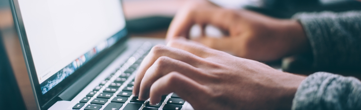 person at laptop keyboard