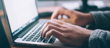 person at laptop keyboard